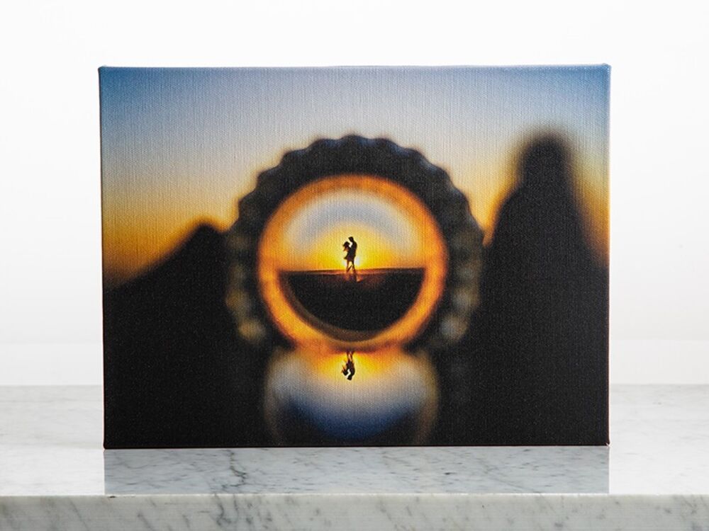 A gallery-wrapped canvas print standing on a marble shelf